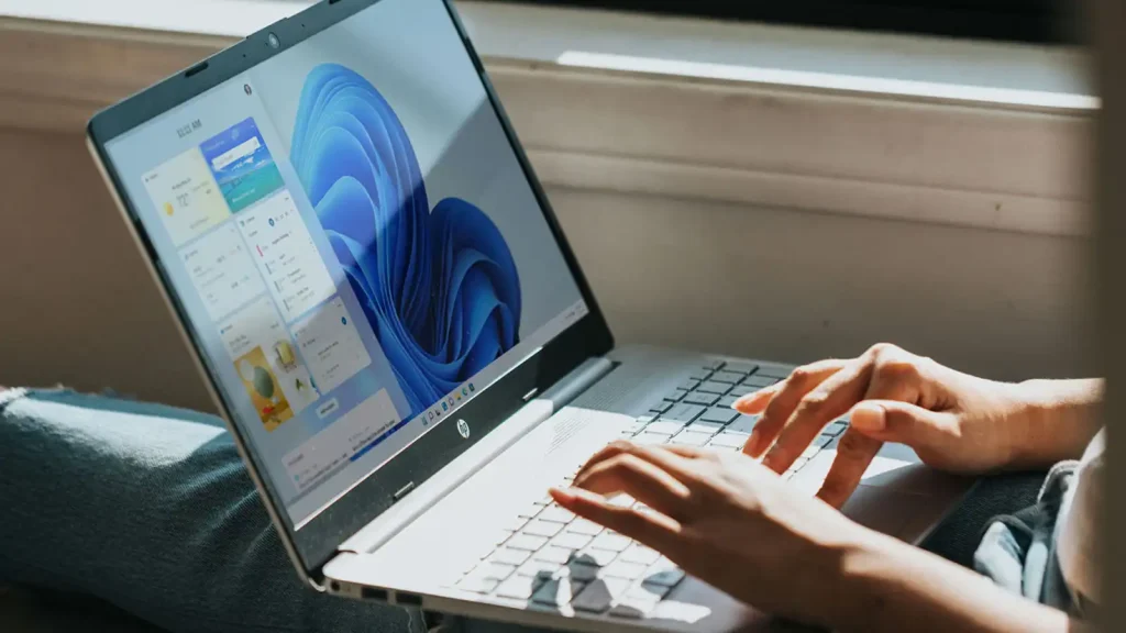 Person-using-Windows-11-laptop-on-lap